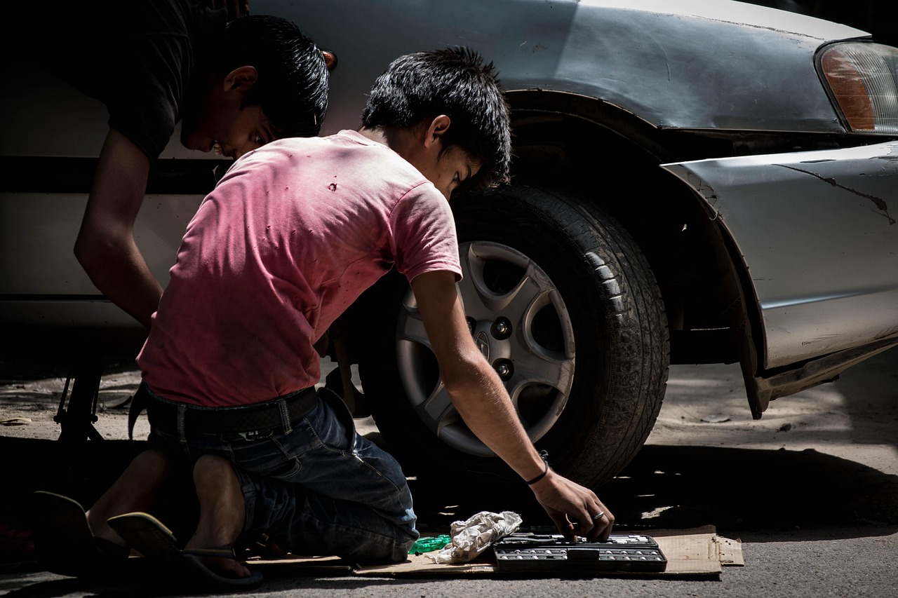 auto mechanic servicing hybrid car