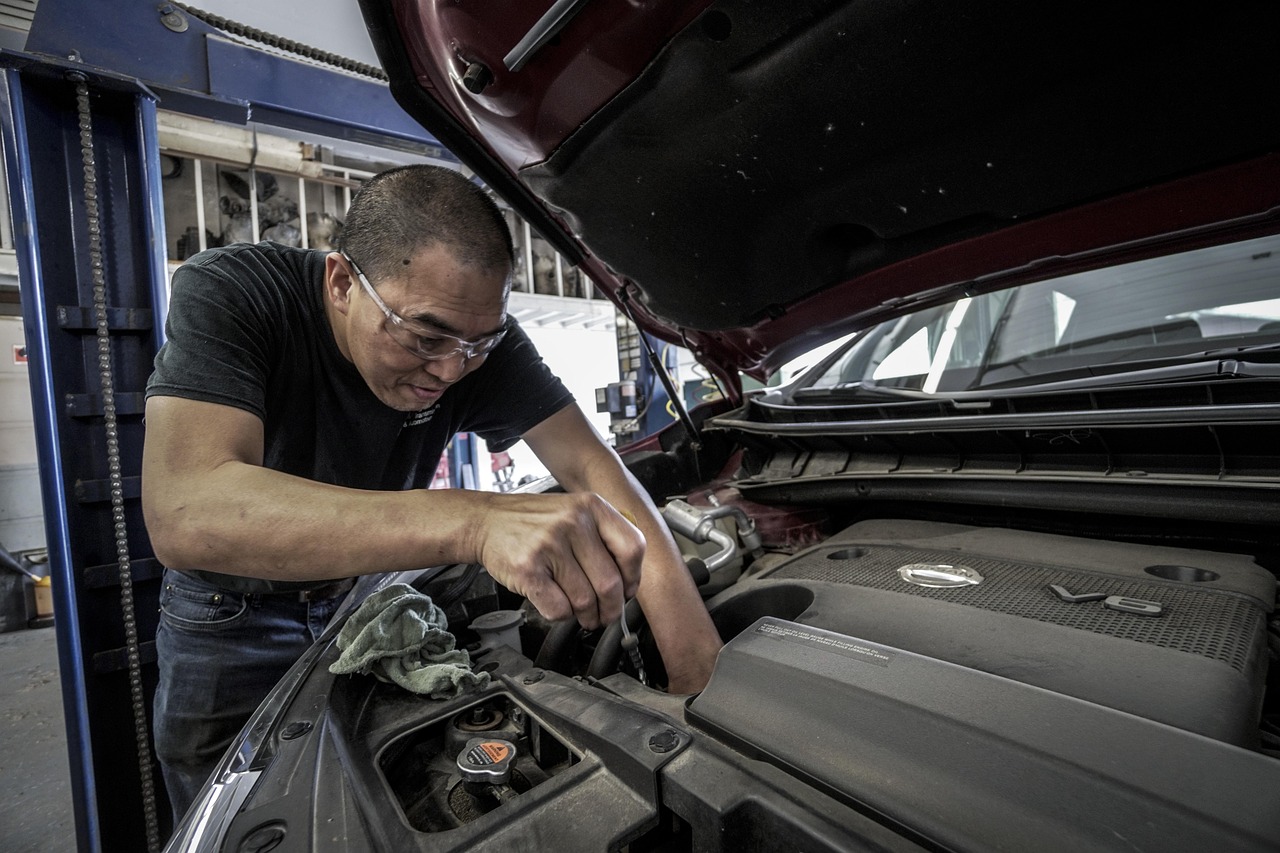 auto mechanic diagnosing car engine