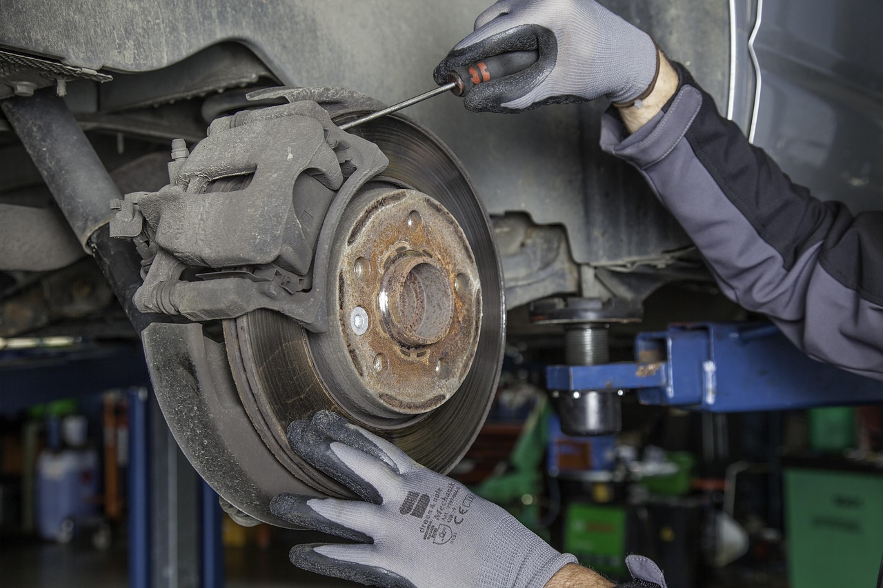 auto mechanic photographing worn brake part